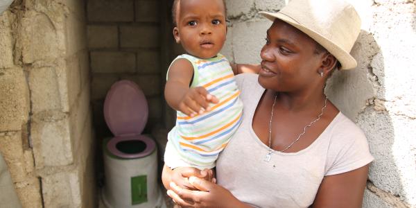 SOIL client with child and household toilet.
