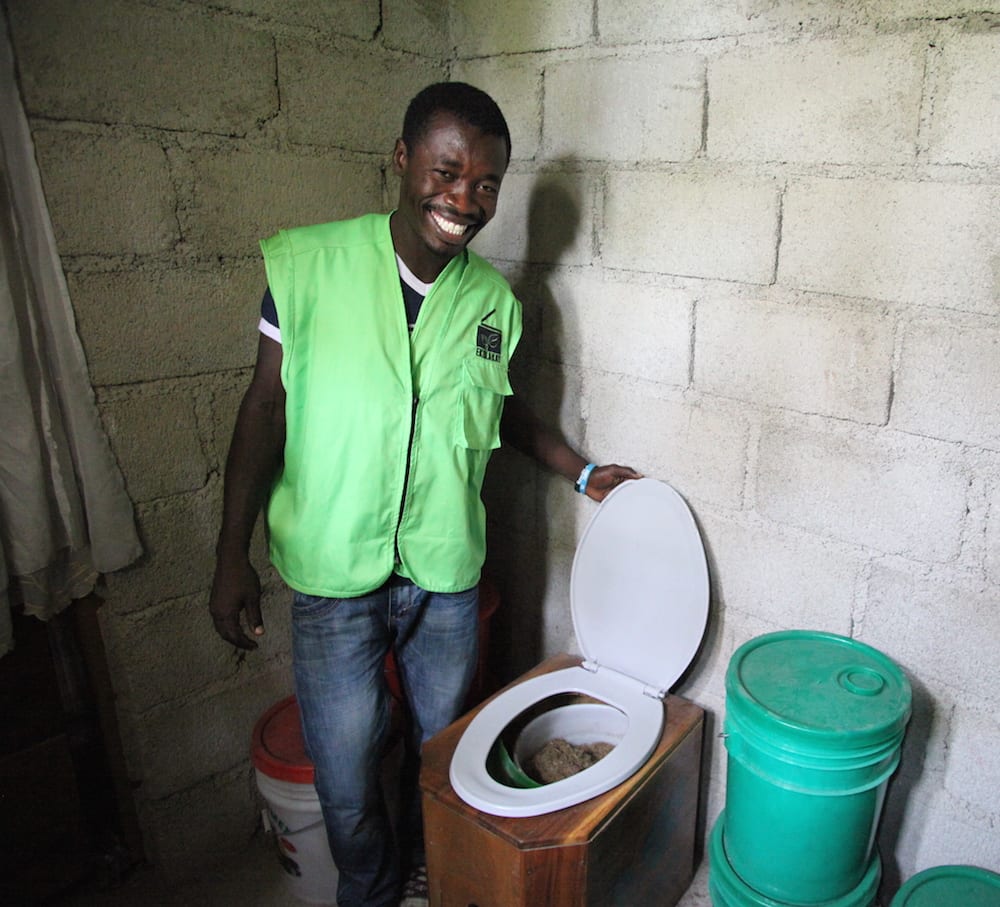 SOIL's Port-au-Prince EkoLakay Coordinator, Herby Sanon, checks a newly installed EkoLakay toilet. Photo credit: Vic Hinterlang.